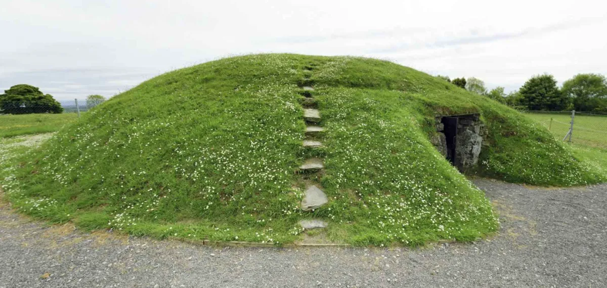 The grass-covered mound of Fourknocks passage tomb with its stone entrance