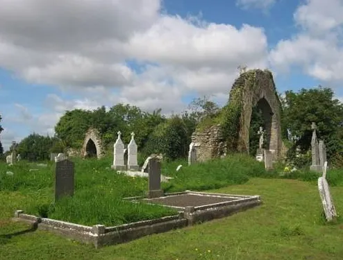 The ivy-covered ruined arches of the old church in Moorechurch Cemetery